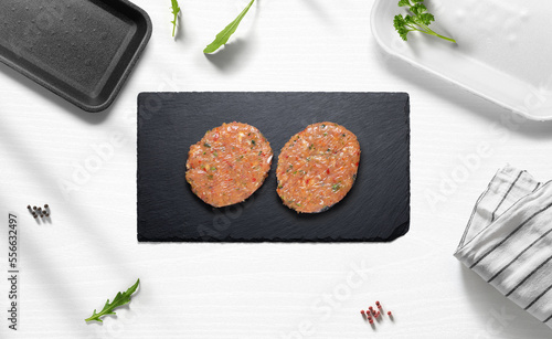 Chicken hamburguers on a flat lay of a kitchen with various items photo