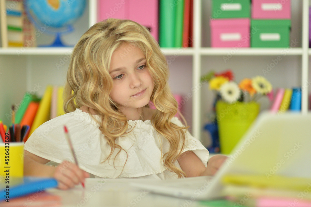 girl using laptop at desk at home girl using laptop at desk at home