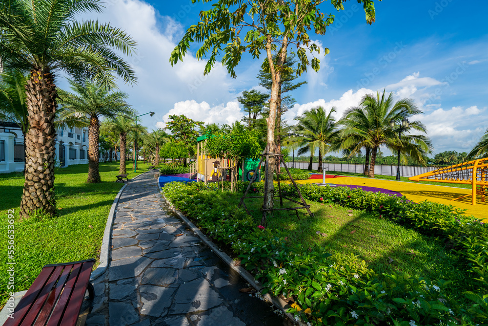Public green park with modern blocks of flats and blue sky with white clouds in Vietnam Public green park with modern blocks of flats and blue sky with white clouds in Vietnam