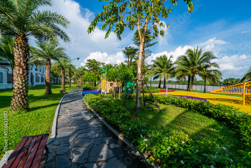 Public green park with modern blocks of flats and blue sky with white clouds in Vietnam