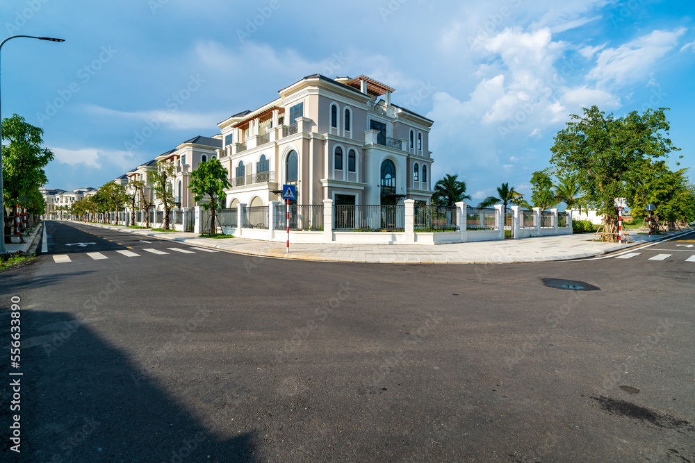 Public green park with modern blocks of flats and blue sky with white clouds in Vietnam