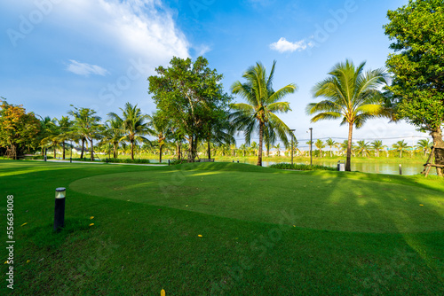 Public green park with modern blocks of flats and blue sky with white clouds in Vietnam