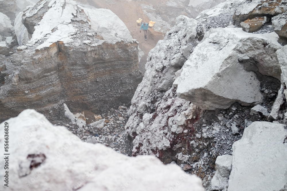 Fototapeta premium Mount Ijen Crater is a tourist spot that has a number of interesting panoramas such as blue fire and sunrise. Tourists can observe the activities of sulfur miners in extreme environments.