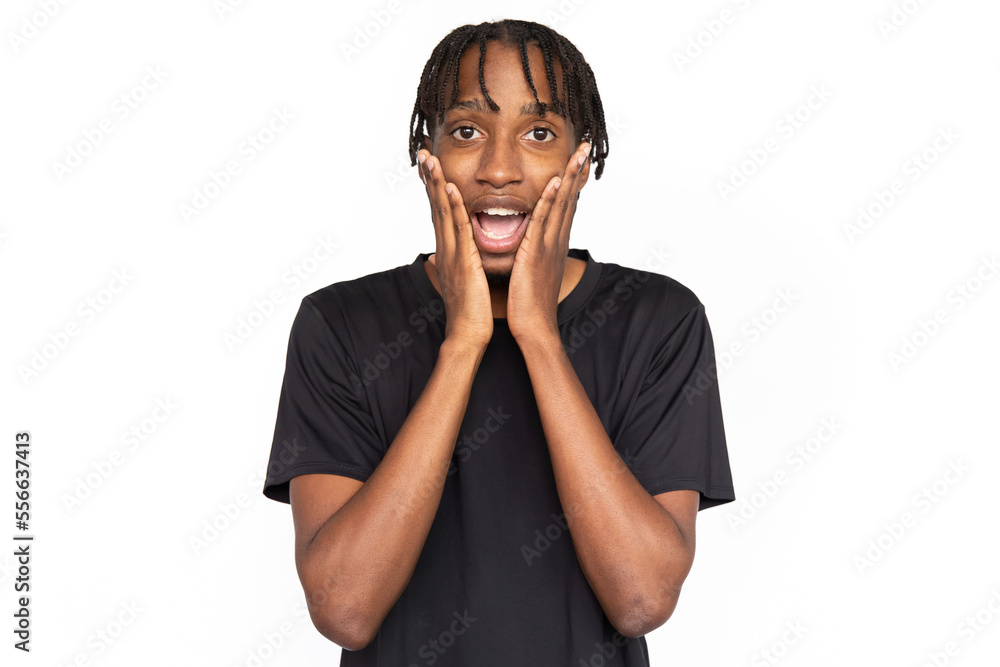 Amazed young man holding his face with hands from shock. Male African American model with brown eyes and afro braids in casual clothes touching his face from surprise. Astonishment, amazement concept Amazed young man holding his face with hands from shock. Male African American model with brown eyes and afro braids in casual clothes touching his face from surprise. Astonishment, amazement concept