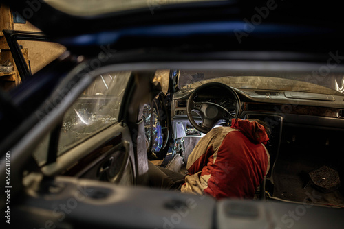 disassemble the center console of the car torpedo for interior detailing and repair. photo