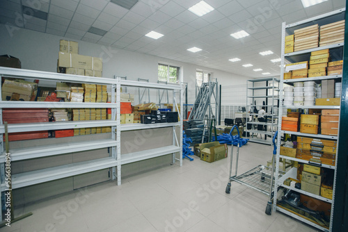 product warehouse in the store. Shelves in the back room. Retail Warehouse full of Shelves with Goods in Cardboard Boxes and Packages. Logistics, Sorting and Distribution Facility for Product Delivery