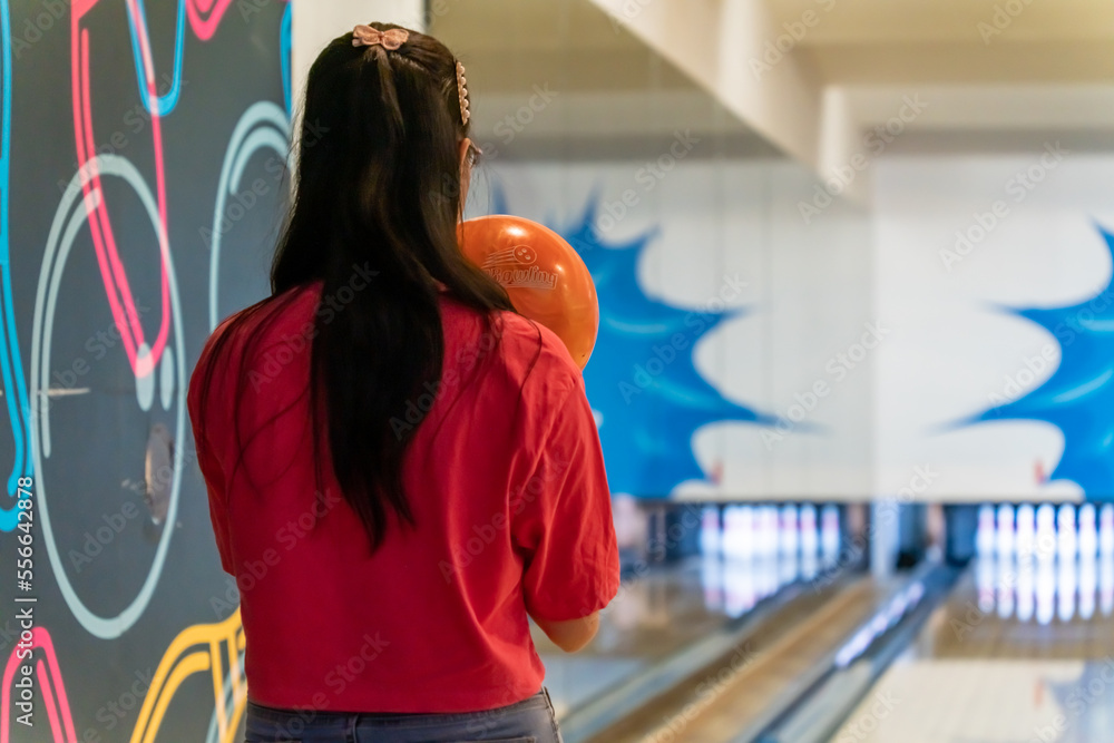 Young asian holding bowling ball, relaxing concept, a woman's hand throws a bowling ball close