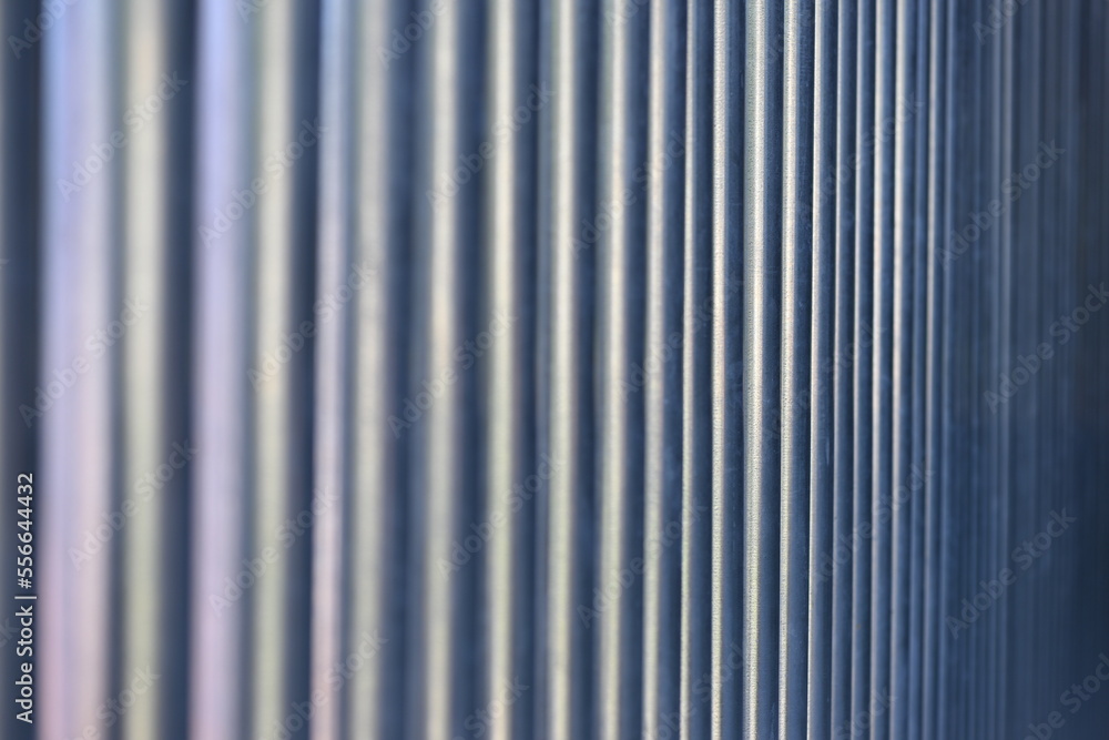 A blurred view to steel pipes in a row. A blurred view to steel pipes in a row.