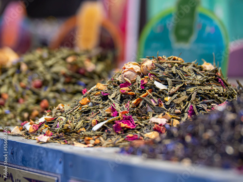 Loose tea leaves on market stand for buying. Tea shop showcase assortment of herbal tea. Bulk organic tea store counter. Aromatic and traditional herbal drinks. Green tea with dry flowers.