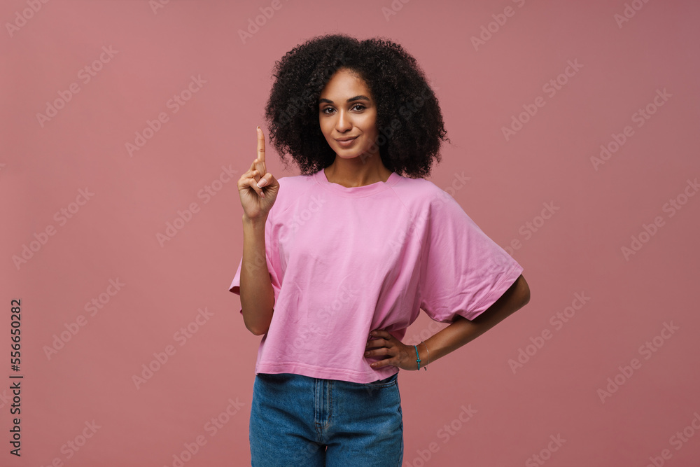 Portrait of young beautiful smiling curly woman doing idea gesture Portrait of young beautiful smiling curly woman doing idea gesture