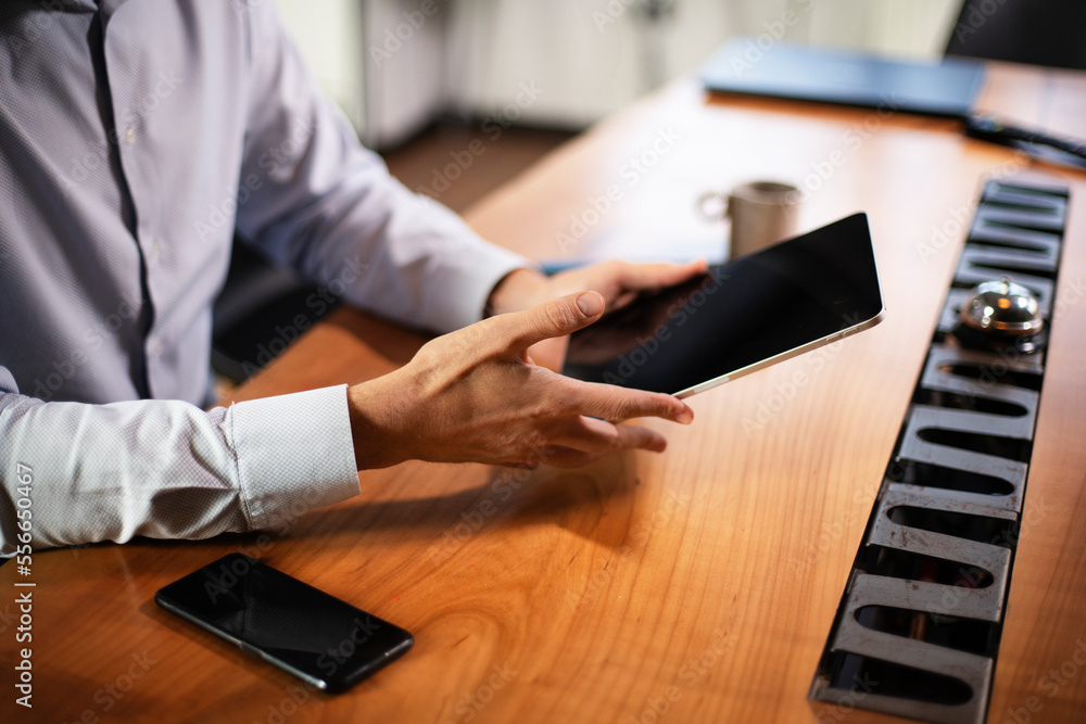Close up of man using digital tablet.. Close up of man using digital tablet..