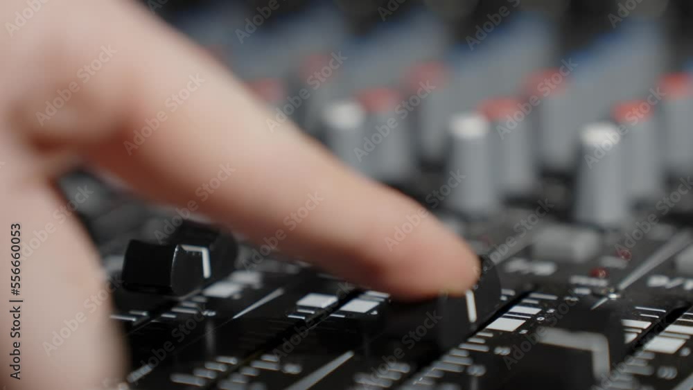 Sound engineer adjusting audio mixer controller for live music, close up Sound engineer adjusting audio mixer controller for live music, close up