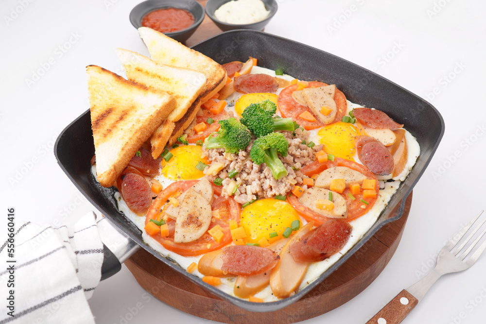 Fast food breakfast, fried eggs in pan and vegetables Fast food breakfast, fried eggs in pan and vegetables