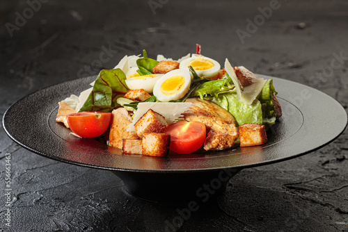 Bild auf Leinwand Caezar salad with chicken breast, tomato, eggs, lettuce and parmesan
