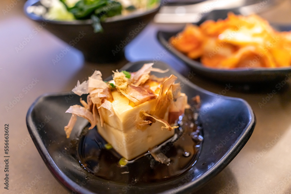 Close up of japanese tofu, Japanese soft cold tofu with sauce in a dish on dining table