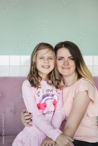 Mother and daughter in pastel interior