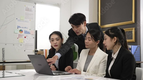 asian business partners sitting in creative meeting room expressing thoughts about online project. their hand gesturing at laptop computer while talking