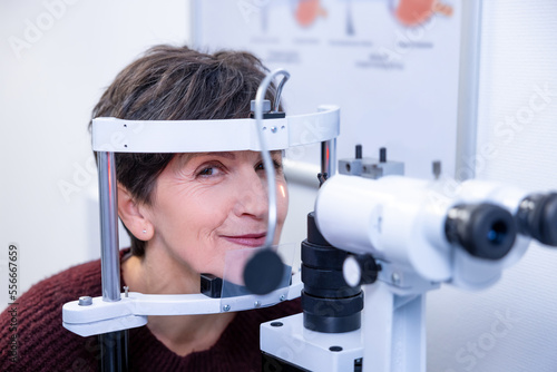 Mid aged woman having an optometric investigation