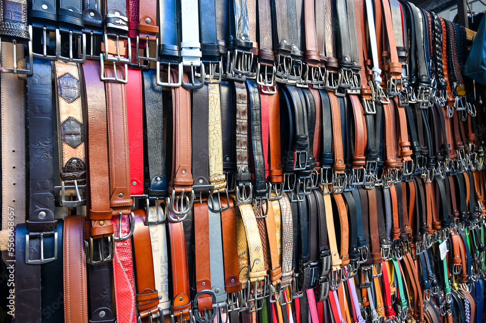 A lot of different belts for sale on street market. 