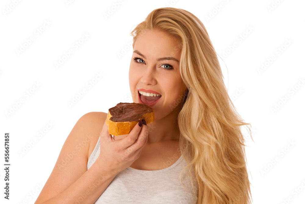 Young blond woman eating breakfast bread and nougat spread isolated over white background