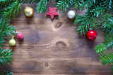 Christmas background with decorations and balls on wooden board