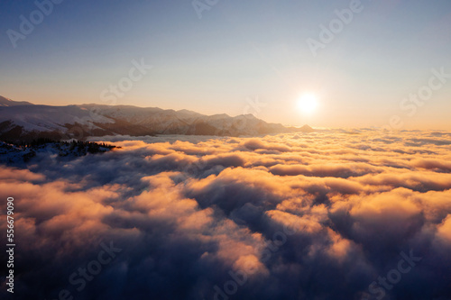 Caucasian mountains above the clouds at the sunset. Cloudscape, aerial view © Mulderphoto