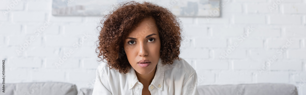 African american woman in shirt looking at camera at home, banner African american woman in shirt looking at camera at home, banner