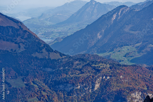 Beautiful aerial view of Swiss Alps with autumn landscape on a blue cloudy autumn day at Axalp, Canton Bern. Photo taken October 18th, 2022, Axalp, Switzerland.