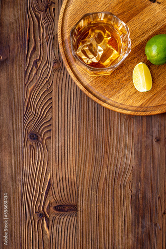 Glass of whiskey or brandy with ice. Strong alcohol background