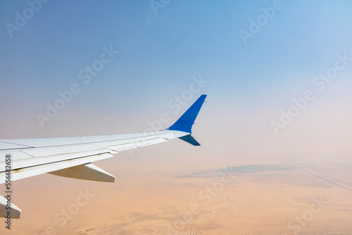 a plane flying over the desert 