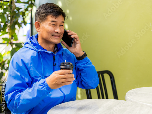 Senior male using smartphone and drinking coffee. senior lifestyle concept.