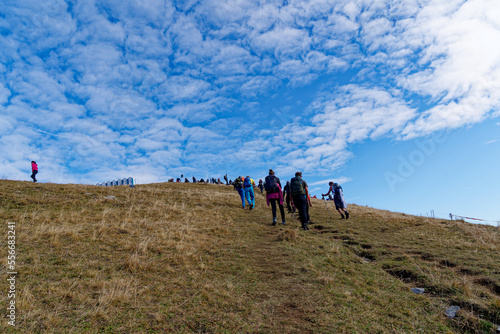 Spectators of 2022 Air Display Axalp of Swiss Air Force on the steep way up in the Swiss Alps to the spectators areas on a sunny autumn morning. Photo taken October 18th, 2022, Axalp, Switzerland. photo