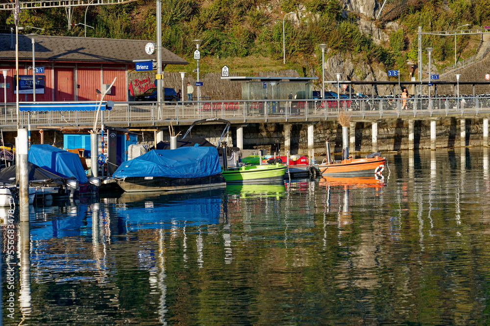 Beautiful scenic landscape with colorful moored boats at Lake Brienz on a sunny autumn late afternoon. Photo taken October 18th, 2022, Brienz, Switzerland.