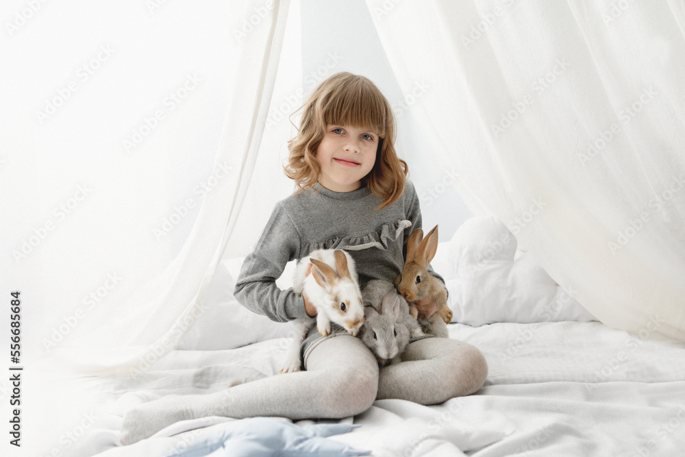Girl with bunny rabbits light interior Girl with bunny rabbits light interior