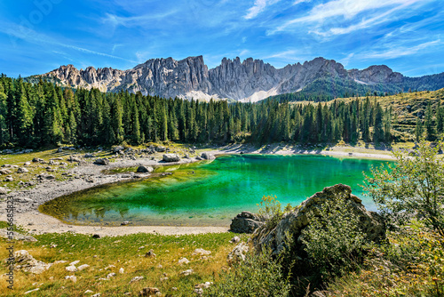 Incredible panoramic view of the Lake Carezza (Italian: Lago di Carezza, German: Karersee), a small alpine lake in the Dolomites in South Tyrol