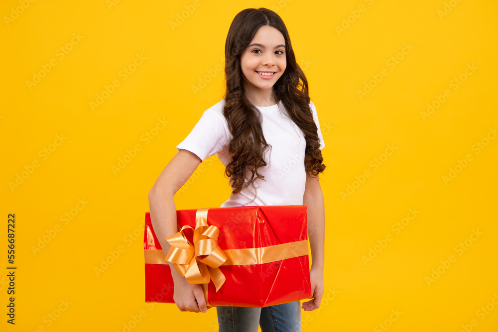 Emotional teenager child hold gift on birthday. Funny kid girl holding gift boxes celebrating happy New Year or Christmas. Happy teenager, positive and smiling emotions of teen girl. Emotional teenager child hold gift on birthday. Funny kid girl holding gift boxes celebrating happy New Year or Christmas. Happy teenager, positive and smiling emotions of teen girl.