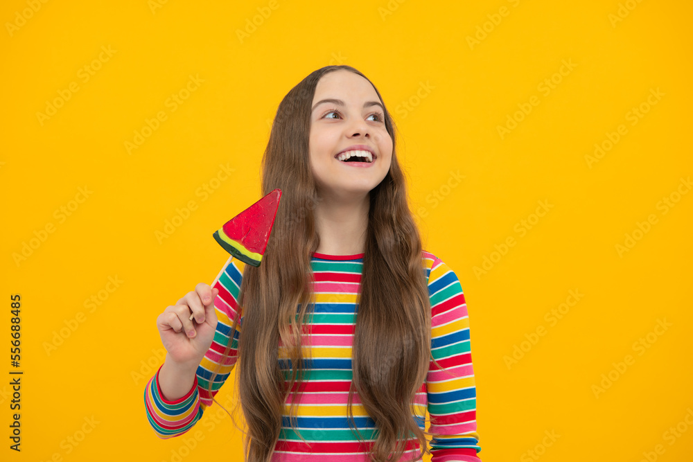 Teen girl hold lollipop caramel on yellow background, candy shop. Teenager with sweets suckers. Teen girl hold lollipop caramel on yellow background, candy shop. Teenager with sweets suckers.