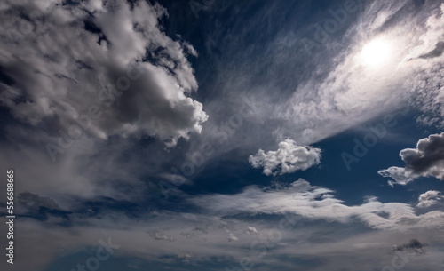 beautiful fluffy white clouds in the blue sky beautiful blue sky with sunlit white clouds as a natural background 