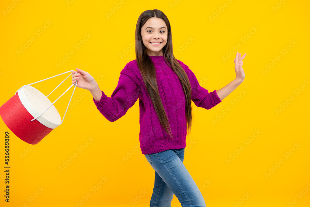 Girl teenager with shopping bags isolated on yellow backgound. Shopping and sale concept.