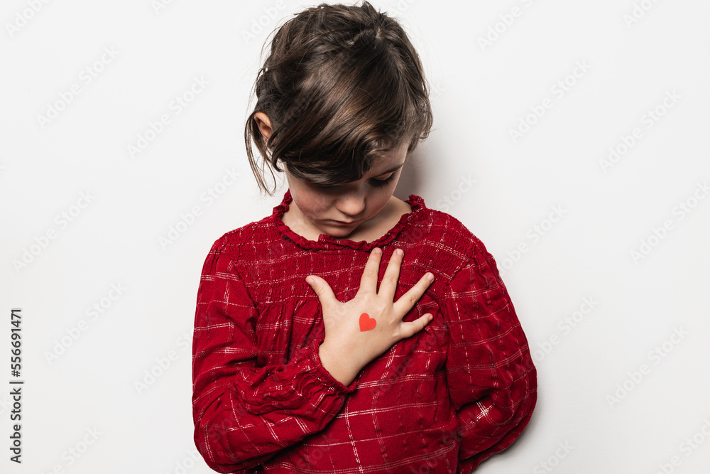 Girl with heart on hand touching chest Girl with heart on hand touching chest