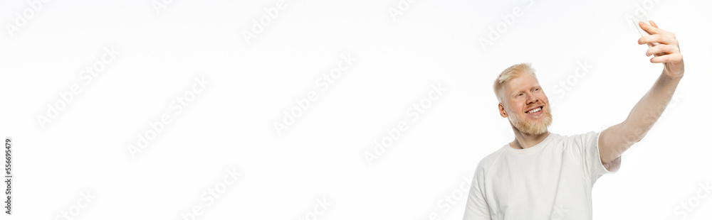 happy albino man in t-shirt taking selfie on smartphone on white, banner happy albino man in t-shirt taking selfie on smartphone on white, banner
