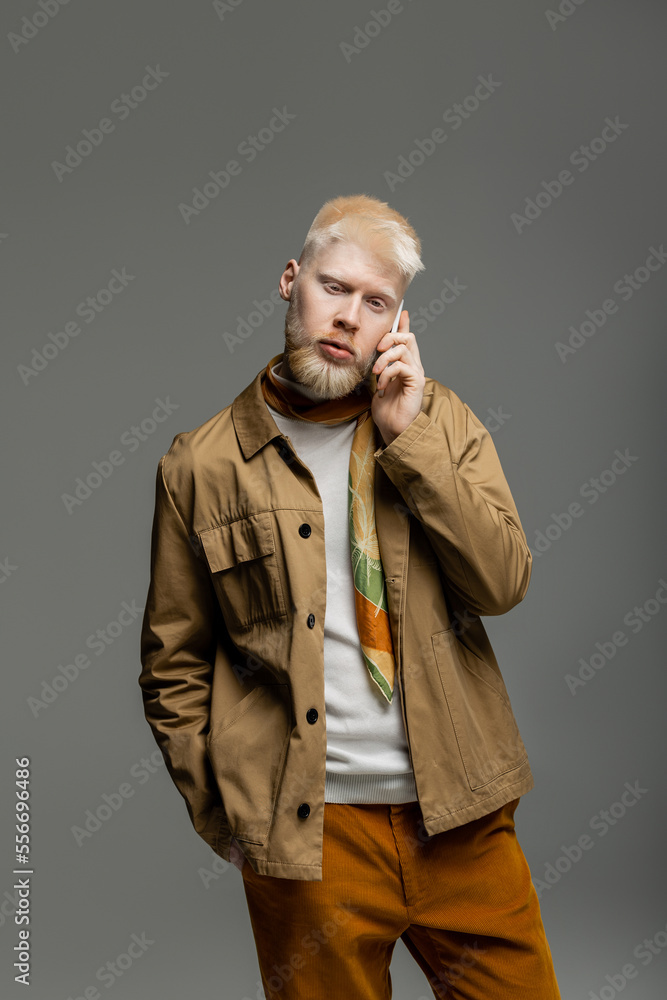 bearded albino man in stylish shirt jacket talking on smartphone isolated on grey bearded albino man in stylish shirt jacket talking on smartphone isolated on grey