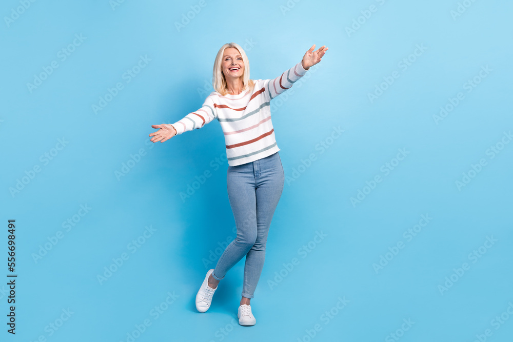 Full length photo of cheerful optimistic lady wear stylish clothes open arms glad see you isolated on blue color background