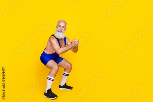Full length photo of funky funny retired man dressed blue overall costume sitting up empty space isolated yellow color background