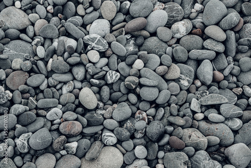 Abstract background with black and gray round sea pebble stones