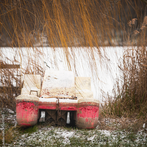Pier at the frozen lake wit...