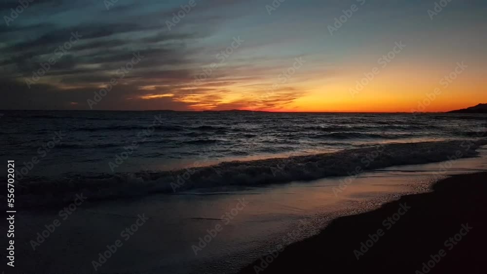 Sunset on the horizon over the Mediterranean Sea viewed from a sandy beach Sunset on the horizon over the Mediterranean Sea viewed from a sandy beach