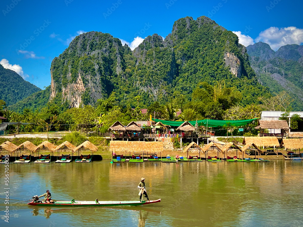 boat on the river with panoramic mountain scenery in Vang Vieng, Laos