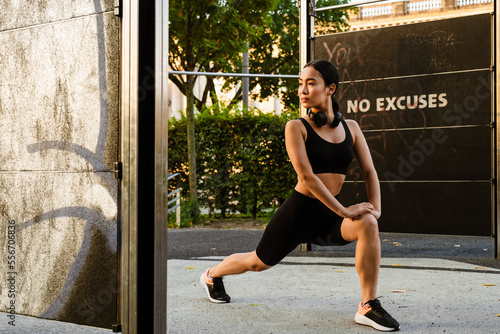 Young asian woman doing exercise during workout on playground