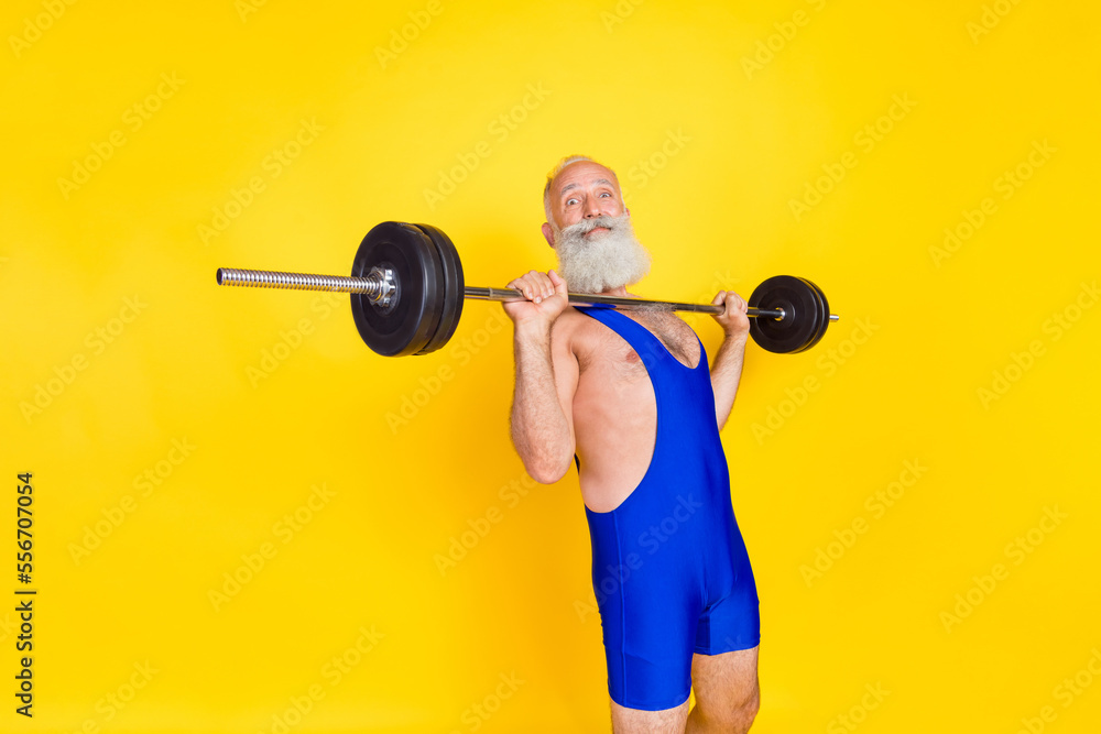 Photo of focused concentrated person wear boxing gloves punch isolated on yellow color background Photo of focused concentrated person wear boxing gloves punch isolated on yellow color background